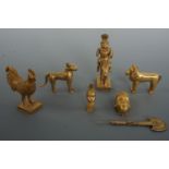 A group of late 20th Century African Benin style cast gilt metal ornaments, tallest 10 cm