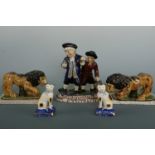 A reproduction Staffordshire figure group, a pair of reproduction Staffordshire lions and a pair