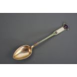 An Art Nouveau enamelled white metal coffee spoon