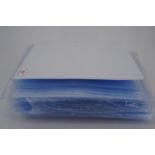 A ring binder together with a large quantity of postcard sleeves