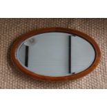 A George V inlaid mahogany oval wall mirror, 63 cm x 40 cm