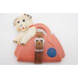 A vintage composition brooch modelled as a Highland terrier in a moderne handbag with leather