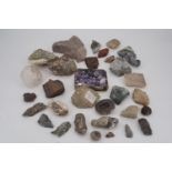A small collection of rocks and minerals including a geode