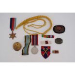 Sundry items of military insignia, campaign medals, an identity disc etc