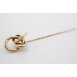 A Victorian yellow metal stick pin, its terminal in the form of an open knot, 9.5 cm, 6.2 g