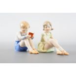 A pair of figurines modelled respectively as a boy reading a book and young girl