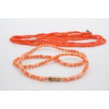A triple-strand pick coral bead necklace and one other coral necklace