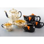 A four-piece lustre tea set and cat-form teapot, cream jug and sugar bowl (a/f)