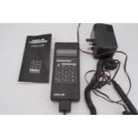 A 1980s Excel M2 Pocket Phone along with charging cables and user guide