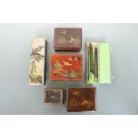 Four Japanese lacquered boxes, one other box and a writing set