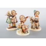 Three Hummel figurines, tallest 14 cm