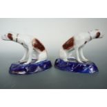 A pair of reproduction Staffordshire hounds, 9.5 cm high
