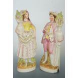 A pair of Staffordshire figures, 31 cm high, (gentleman a/f)
