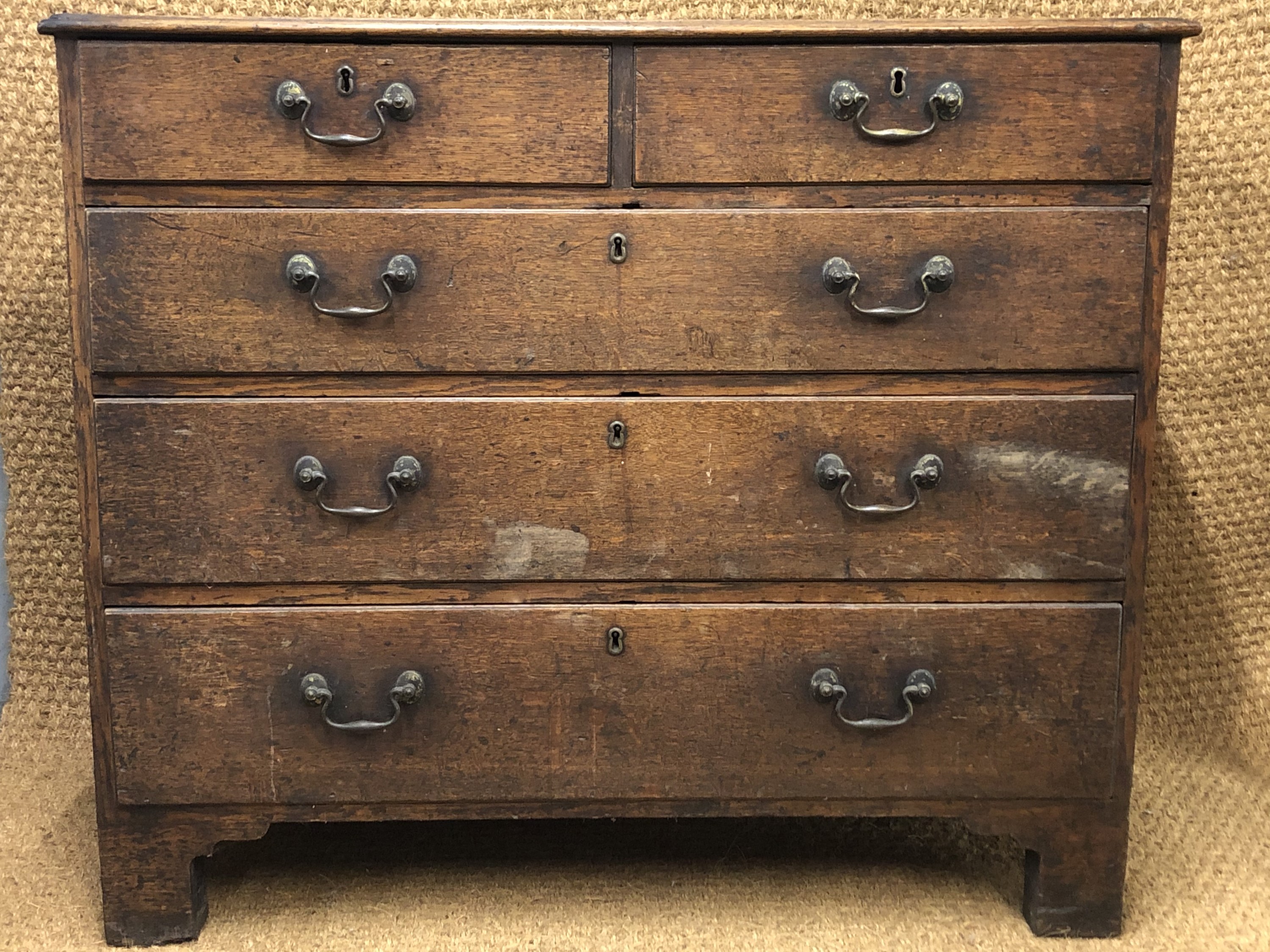 A George III oak chest of two short over three long drawers, having brass bale handles and square - Image 2 of 2
