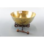 An oriental brass bowl and stand