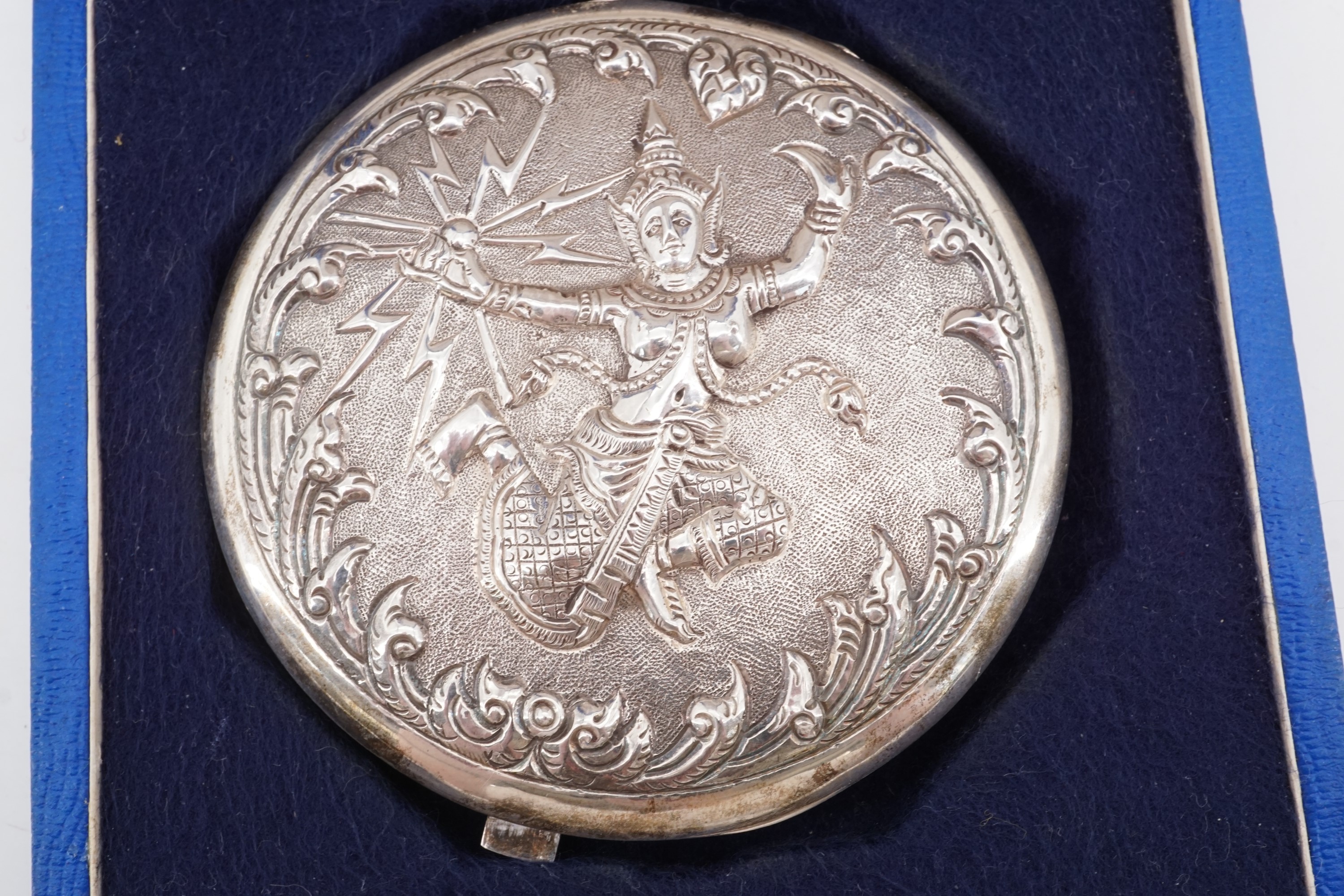 A mid-20th Century Siamese white metal powder compact, the cover repouse worked and engraved in - Image 2 of 3