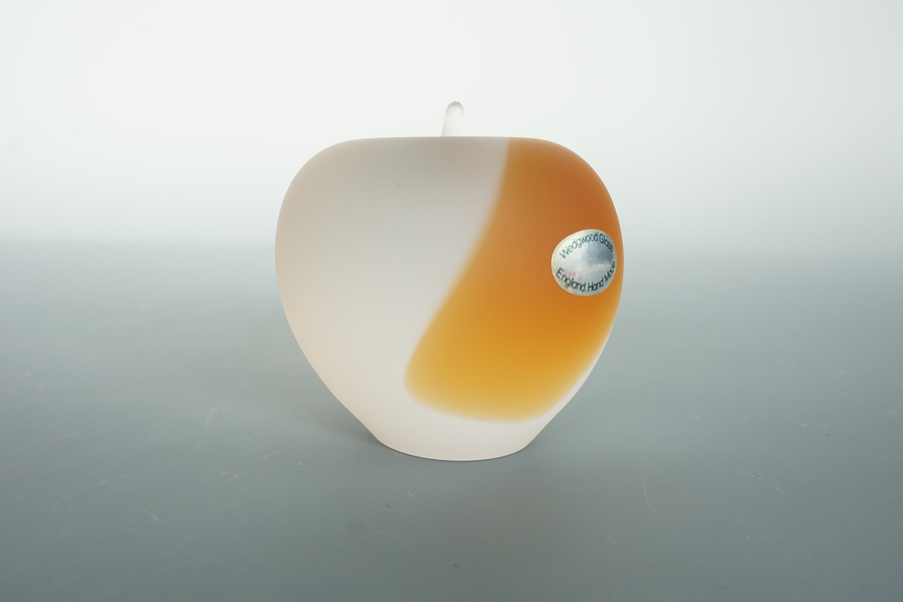 A Wedgwood glass paperweight modelled as an apple