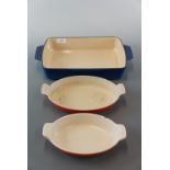A Le Creuset oven dish and two other enamelled iron dishes