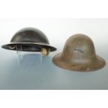 A Second World War Civil Defence helmet together with a Fire Watcher's helmet