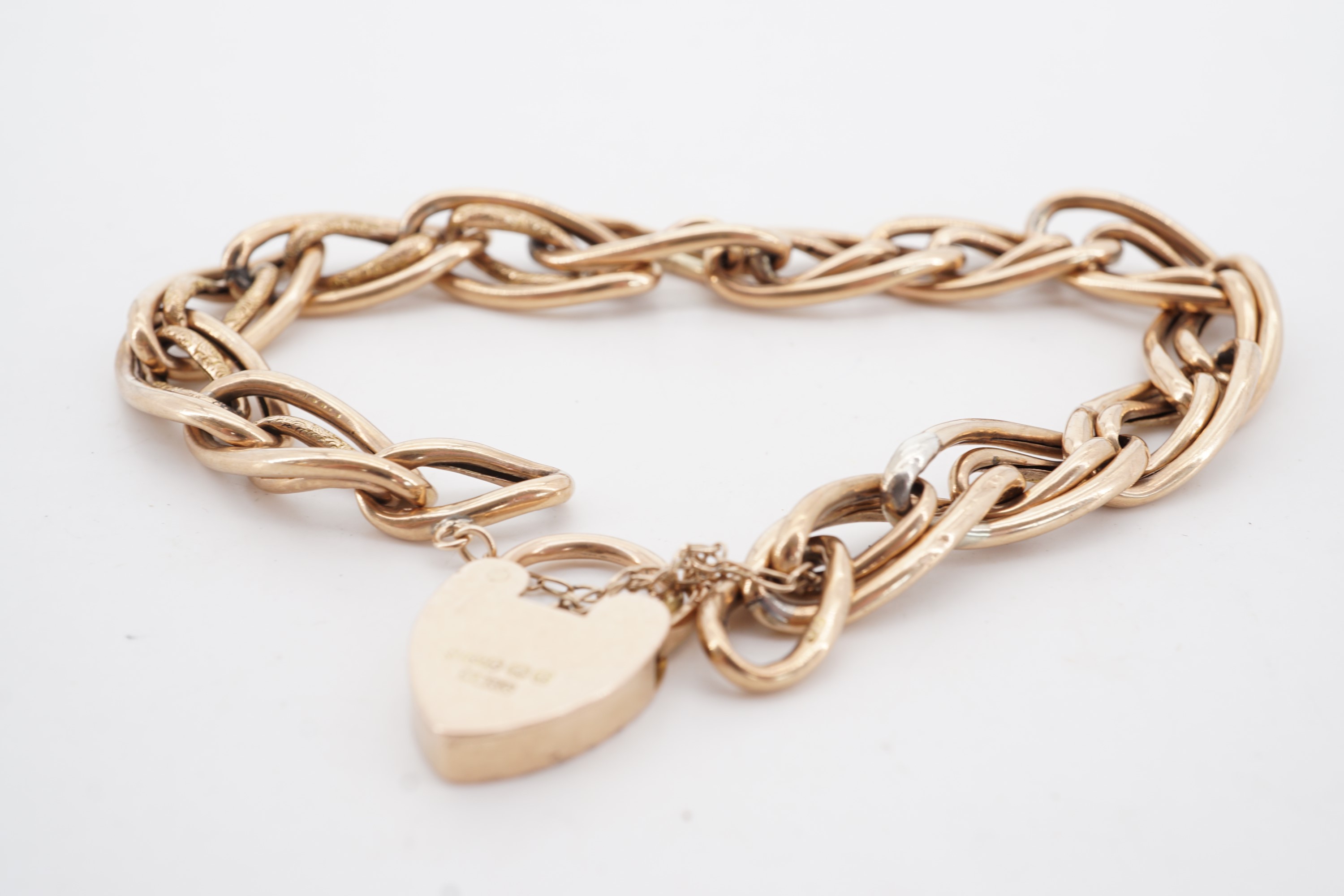 A Victorian yellow metal compound curb link bracelet with 9 ct gold padlock clasp, 14 g