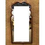 A reproduction 18th Century style mahogany-framed wall mirror, 74 cm x 39 cm