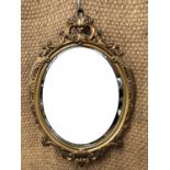 A Rococo influenced gilt-framed wall mirror, 72 cm x 47 cm