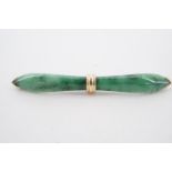 A 9 ct gold mounted jade bar brooch, the spinach jade carved in the form of an archer's bow and