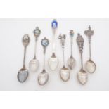 Eight variously enamelled and cast white metal souvenir tea spoons, bearing "sterling", 800 and