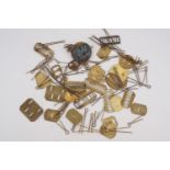 A quantity of cap badge pins etc