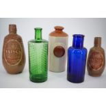 A Victorian Taylor of Liverpool green glass poison bottle, 21 cm, together with other bottles and