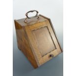 An early 20th Century oak coal box