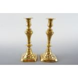 A pair of Victorian brass candlesticks, 24 cm high
