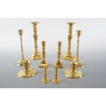 Five pairs of brass candlesticks