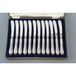 A cased set of twelve electroplate butter knives