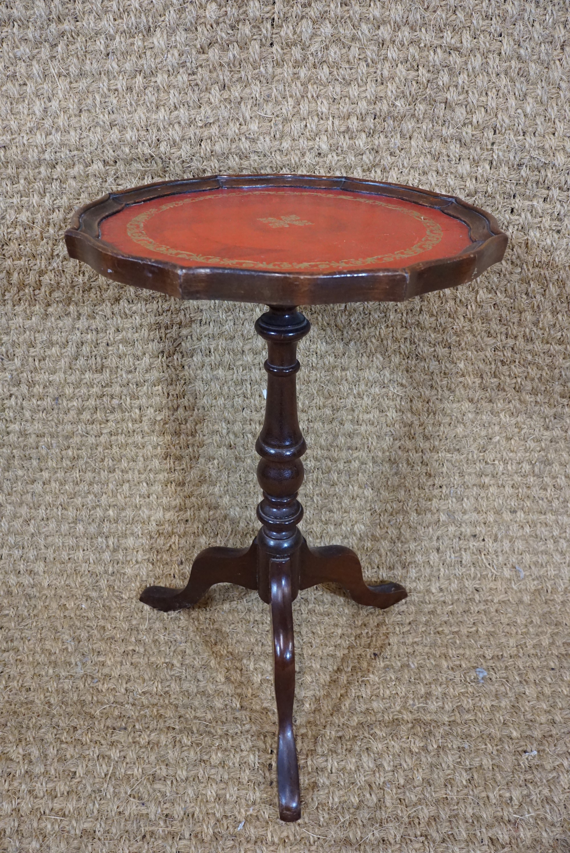A reproduction mahogany tripod wine / lamp table with gilt-tooled leather top