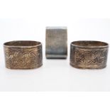 Two Celtic style napkin rings and one other