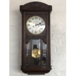 A 1930s oak wall clock, 76 cm