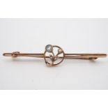 An early 20th Century yellow metal bar brooch, comprising a pair of fine parallel bars centred by