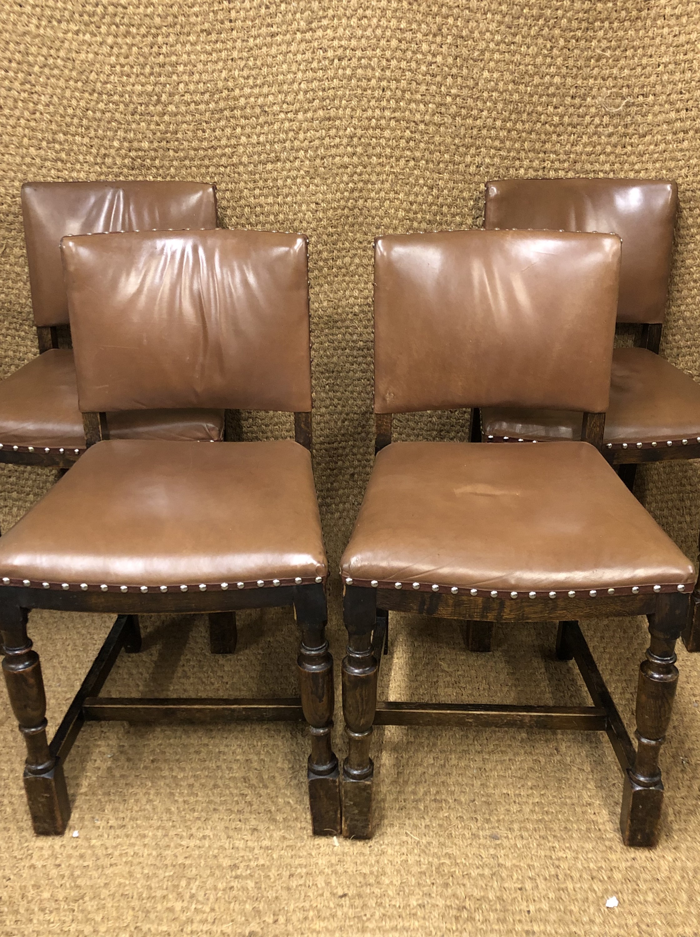 Four 1930s hide upholstered oak dining chairs