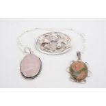 A white metal mounted rose quartz cabochon pendant and neck chain, one other similar pendant and a