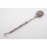An Edwardian silver-handled button hook, the terminal modelled as a thistle and set with an