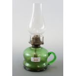 A green glass oil lamp, 28 cm