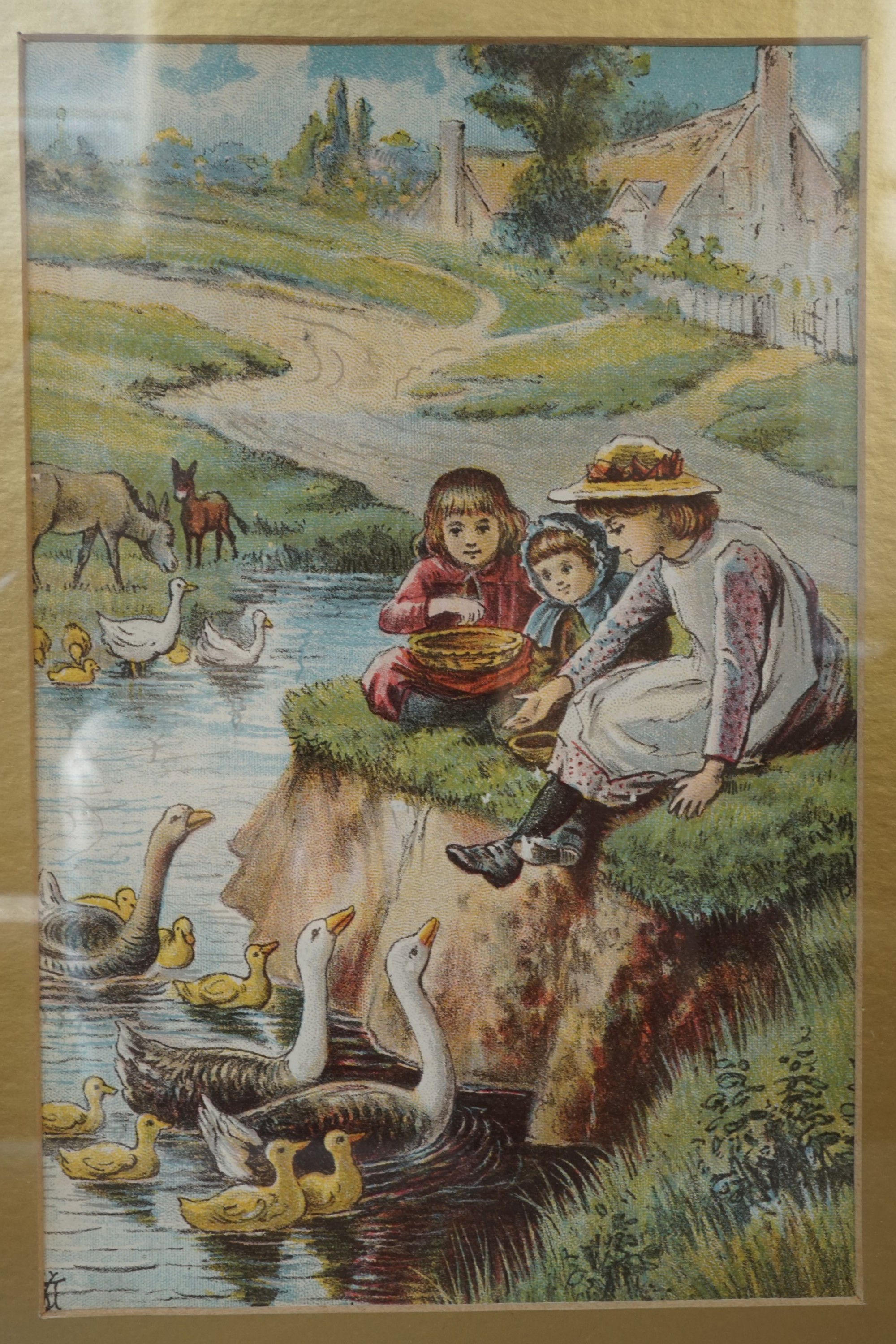 A late 19th Century lithograph depicting three young children feeding geese from a river bank, in