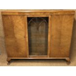An astragal-glazed walnut side cabinet, 137 cm x 117 cm high