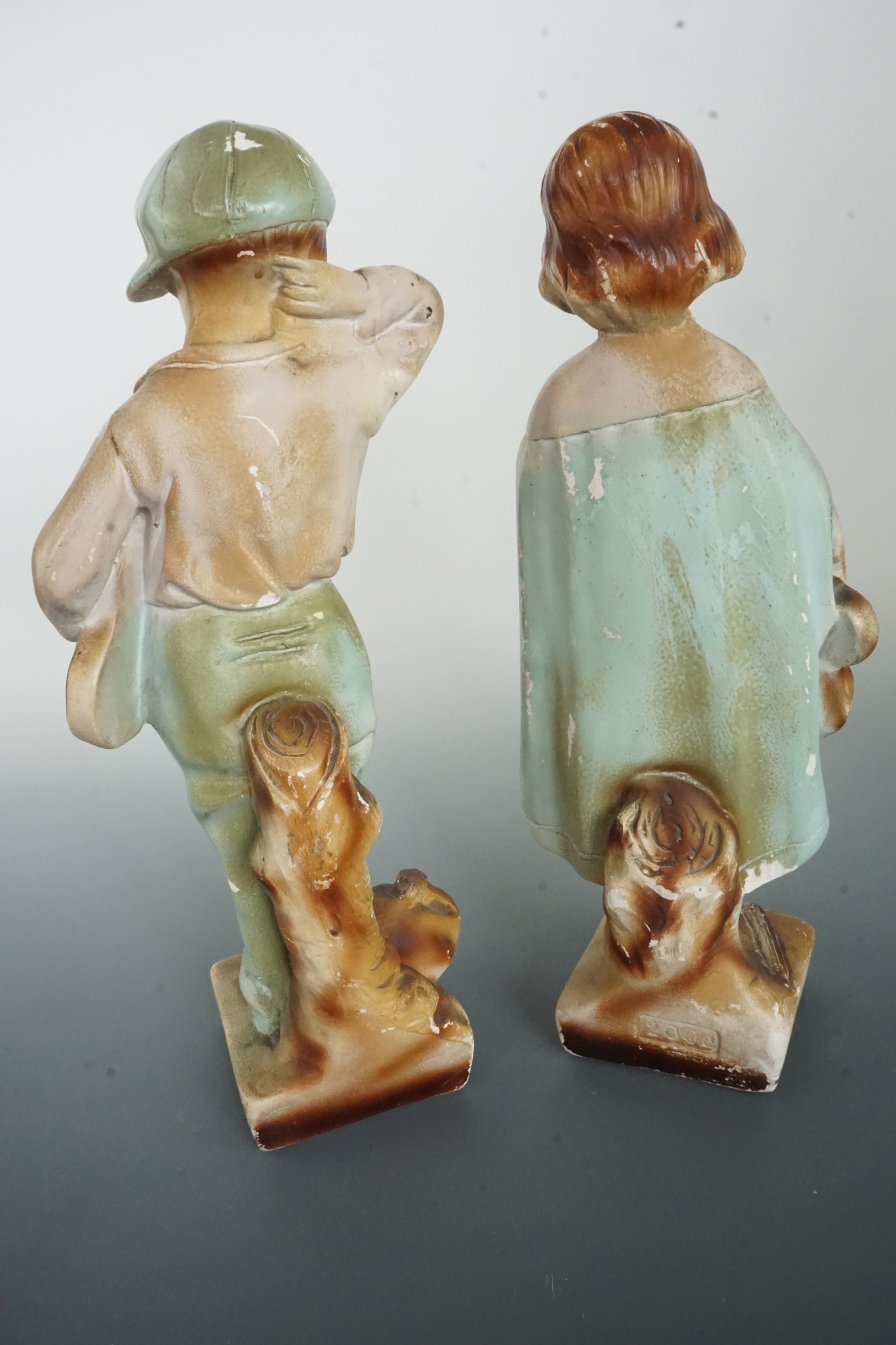 A pair of mid-20th Century kitsch plaster figurines modelled a young boy and girl, entitled "I - Image 3 of 3