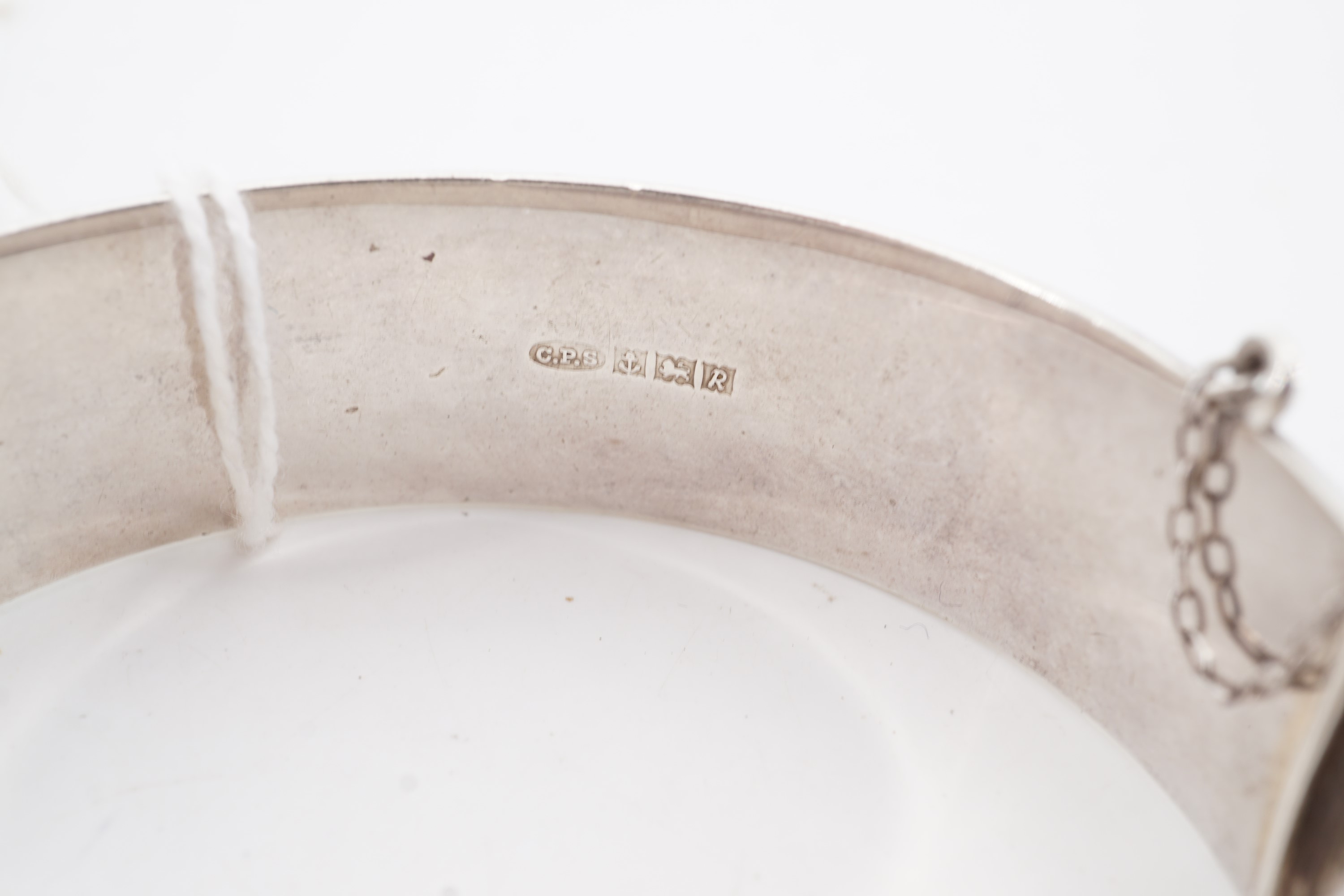 A silver hinged D-section bangle, bearing engraved foliate scroll decoration, Birmingham, 1966 - Image 2 of 2
