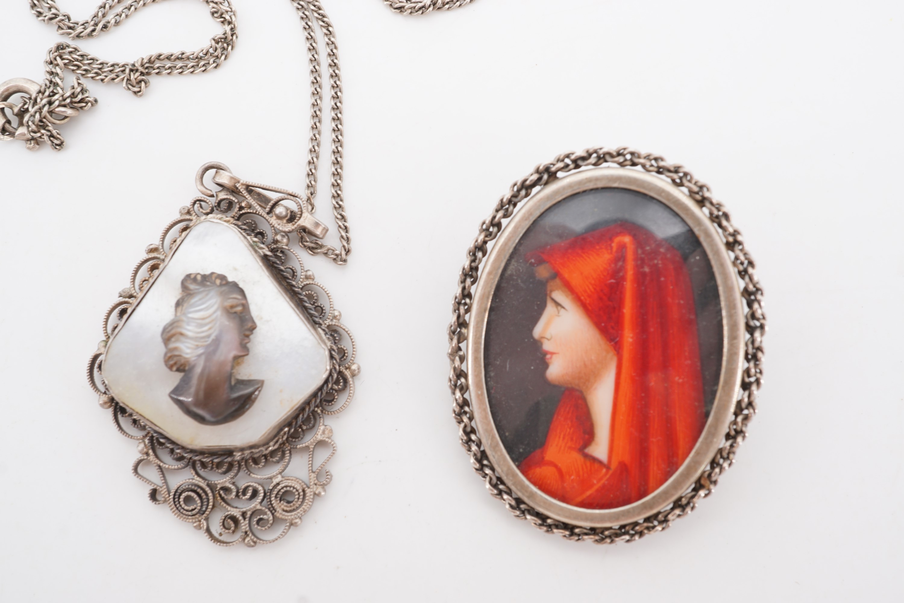 An Italian white metal brooch incorporating a portrait miniature, together with a filigree and