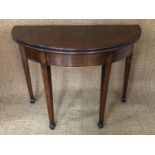 A George III string-inlaid and cross-banded mahogany half-moon turn-over-top tea table