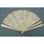 A mid 19th Century Chinese export ivory brise fan, the sticks intricately reticulated and carved