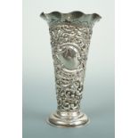 A Victorian reticulated silver spill vase of Rococo design, funnel form with a wavy everted rim